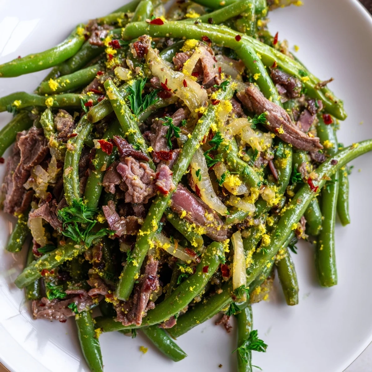 Lemon Garlic Green Beans with Bacon Beef served warm in a skillet, featuring tender-crisp green beans tossed with savory beef and bacon in a glossy sauce.