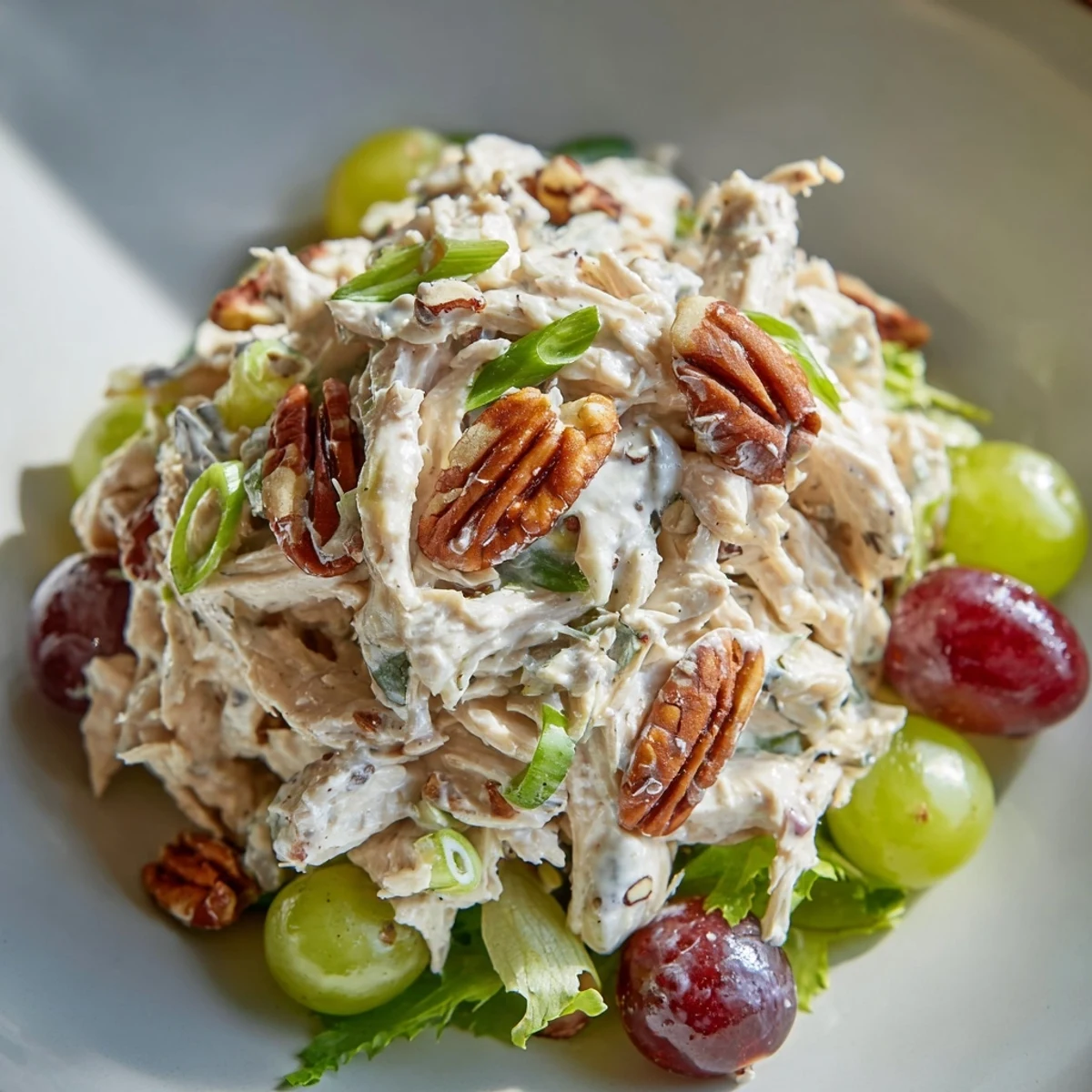 Savory Chicken Salad with Pecans includes diced chicken, crunchy pecans, and vibrant green onions, perfect for a hearty lunch sandwich or light dinner.