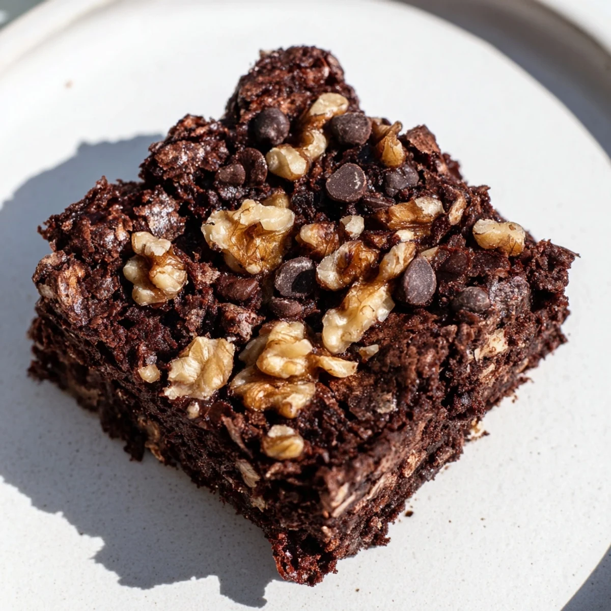 Freshly baked Chocolate Brownies with Walnuts cut into squares on a cooling rack, revealing a moist, fudgy crumb with visible nut pieces.