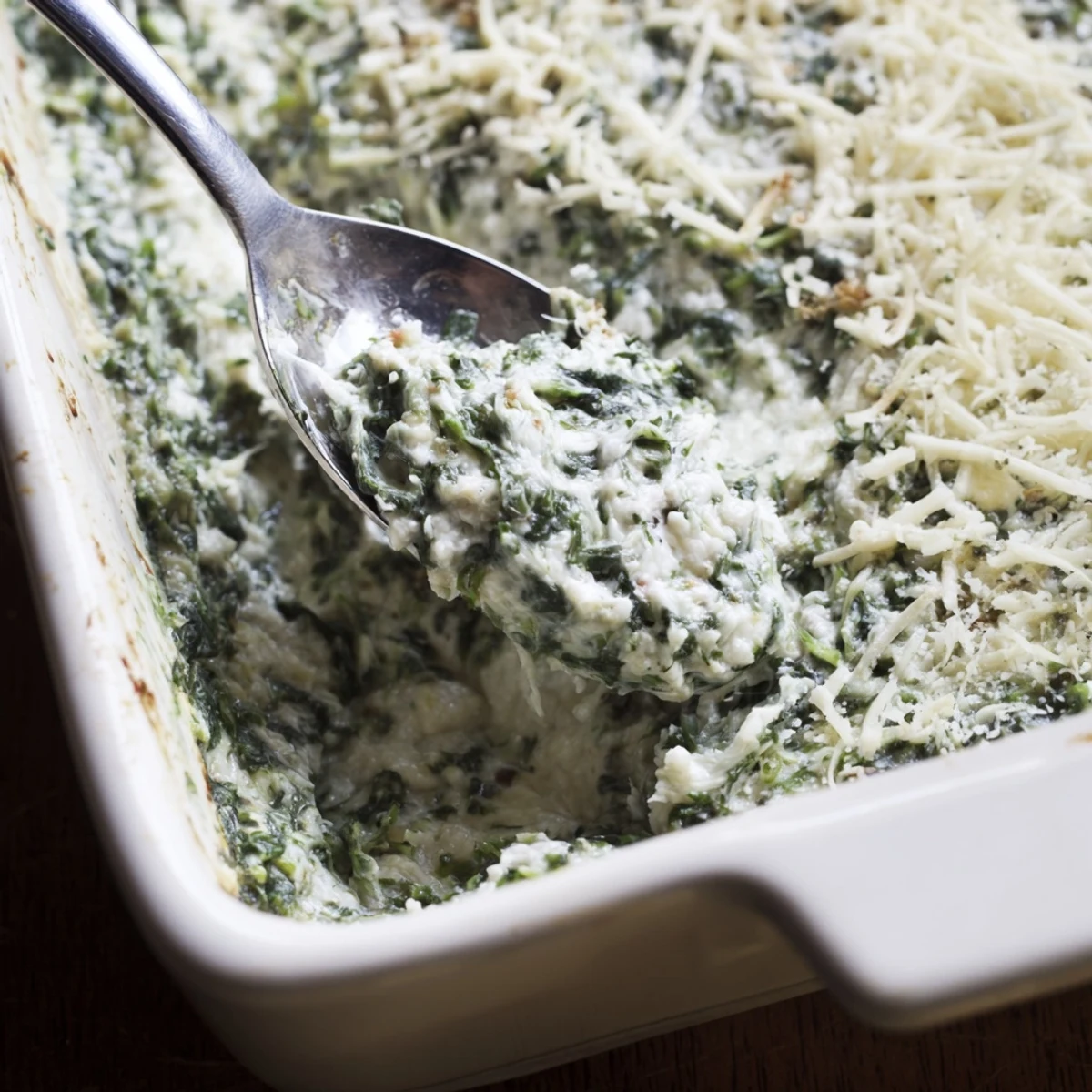 Creamy Spinach Dip with Sourdough Bread served warm and bubbling from the oven, paired with rustic bread slices for dipping.