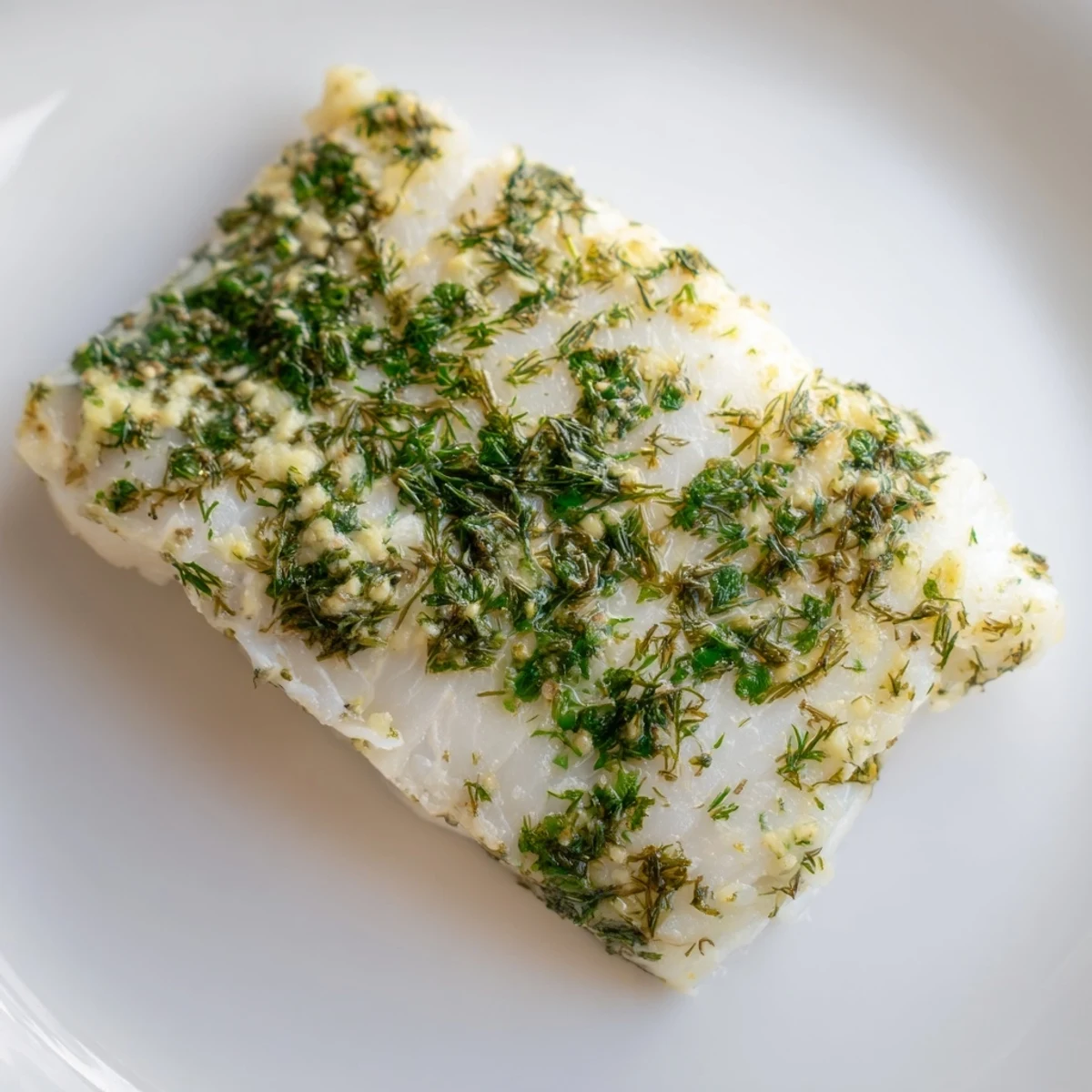 Close-up of Baked Cod with Herb Butter flaking easily with a fork, revealing tender, moist interior.