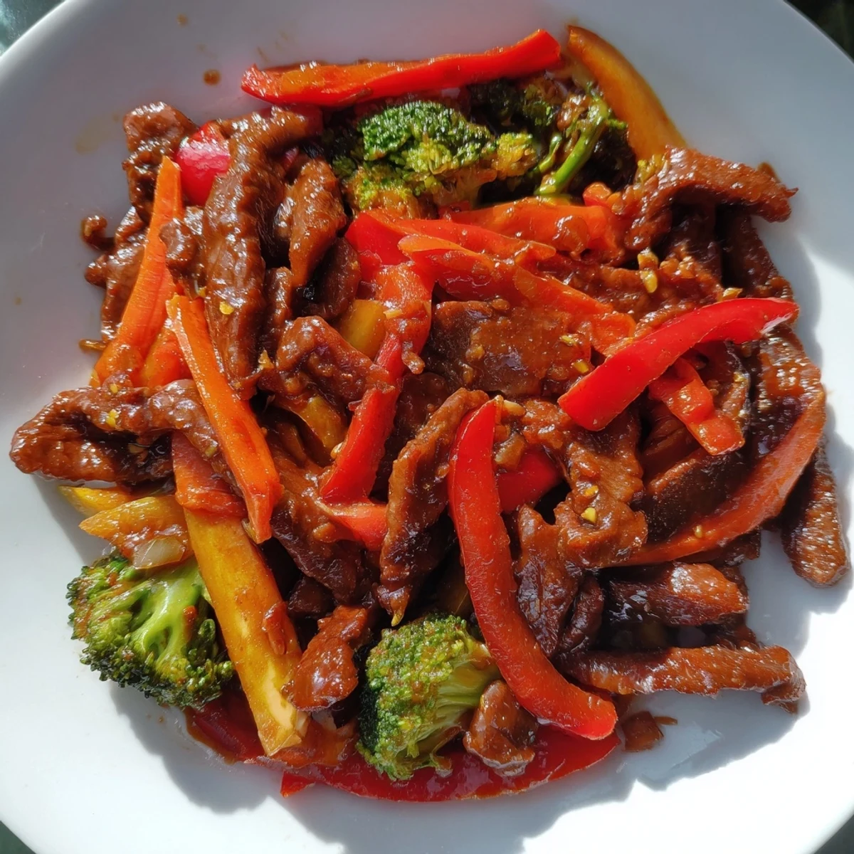 Savory Spicy Stir Fry Beef with Veggies served over fluffy white rice, garnished with sesame seeds.