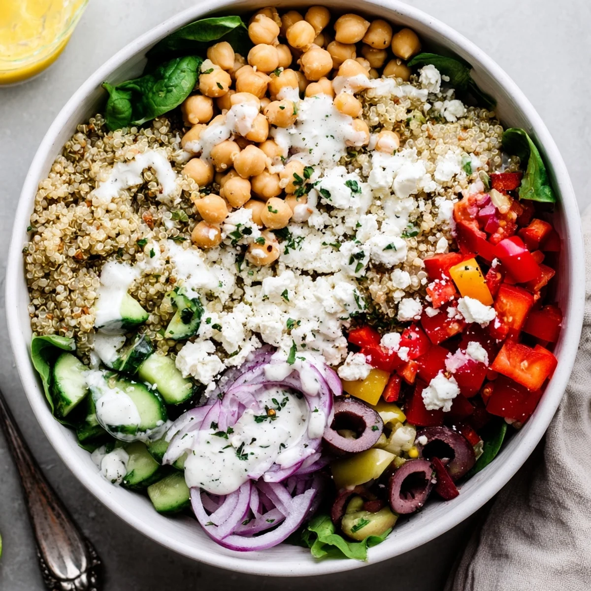 This Mediterranean Dinner Grain Bowl is topped with chickpeas, feta, Kalamata olives, and parsley.