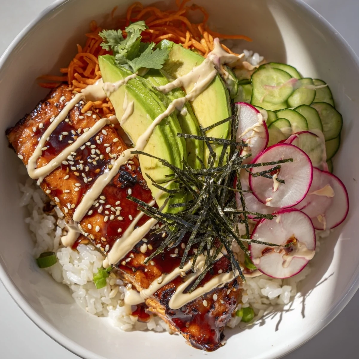 Golden glazed salmon rests on jasmine rice in teriyaki salmon rice taco bowls with pickled veggies, fresh cilantro, and drizzles of sriracha mayo.