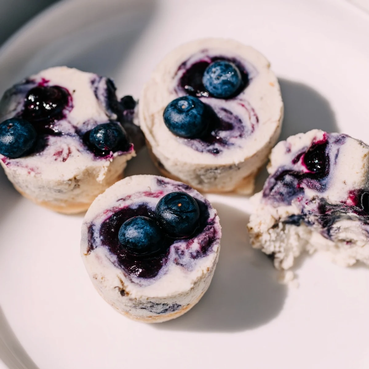 Close-up of Blueberry Cheesecake Protein Bites revealing the almond flour base and creamy cheesecake texture, ready for a healthy snack.