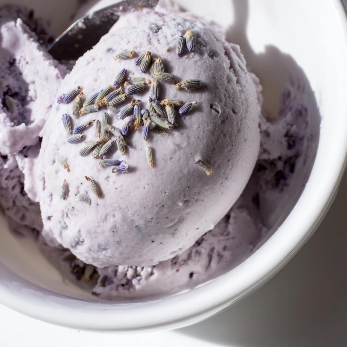 Lavender Ice Cream being scooped from a container, revealing a creamy purple-hued texture.