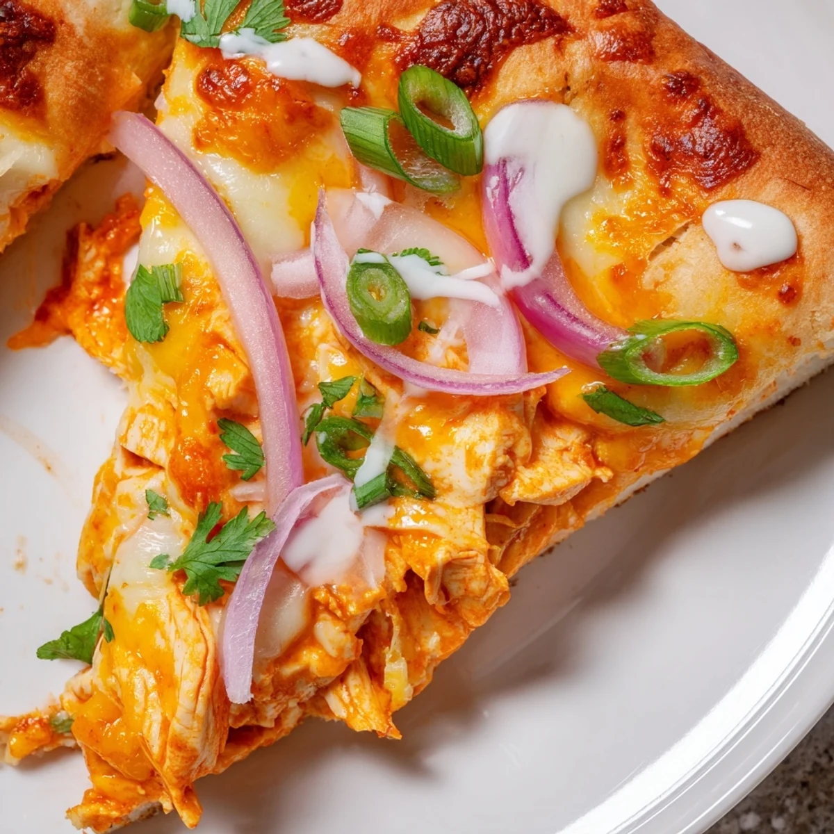 Slice of Bold Buffalo Chicken Pizza with melted mozzarella and cheddar, crispy crust, and extra buffalo sauce drizzle served on a rustic board.