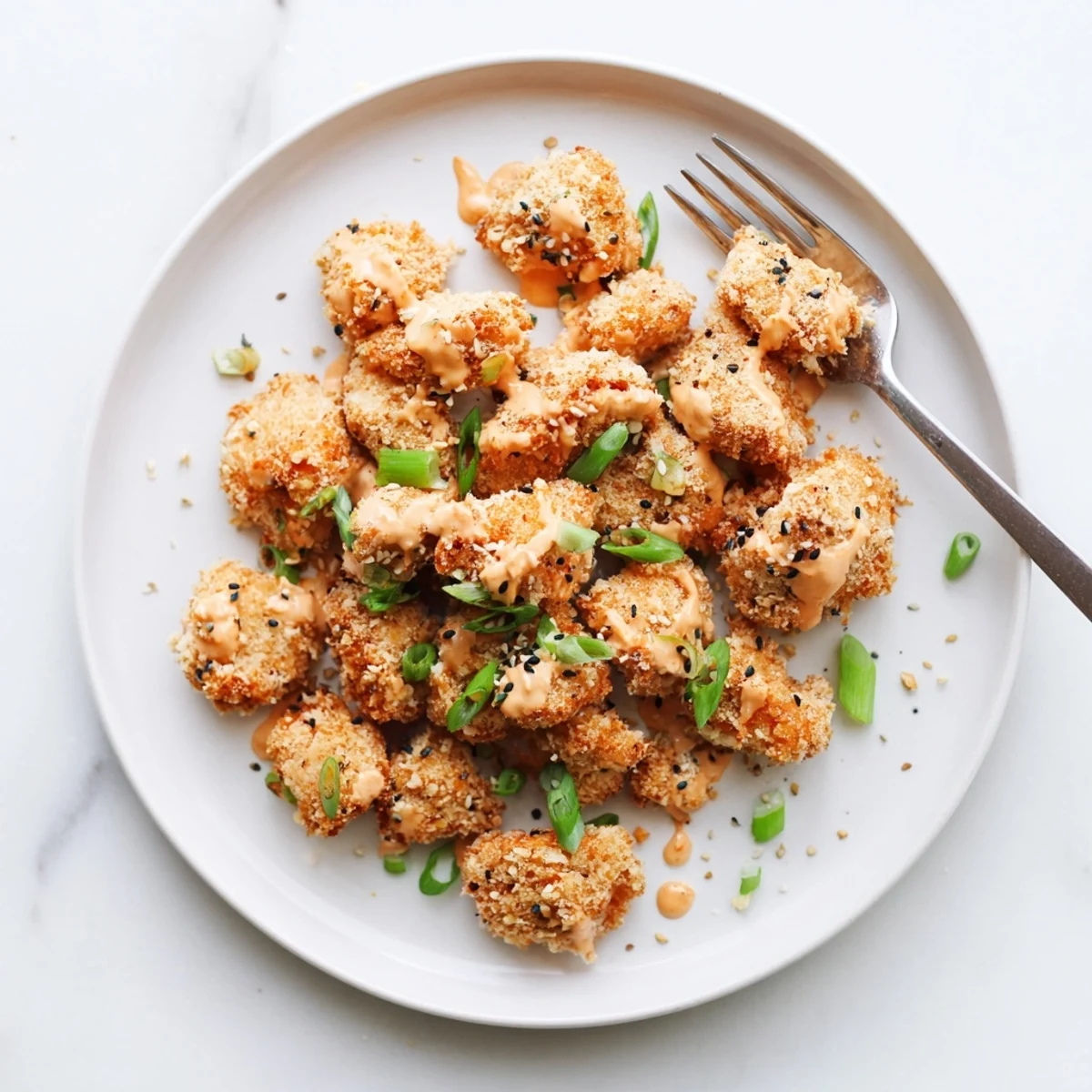 Platter of low carb bang bang chicken served hot with a vibrant pink sauce, perfect for a quick and satisfying dinner.