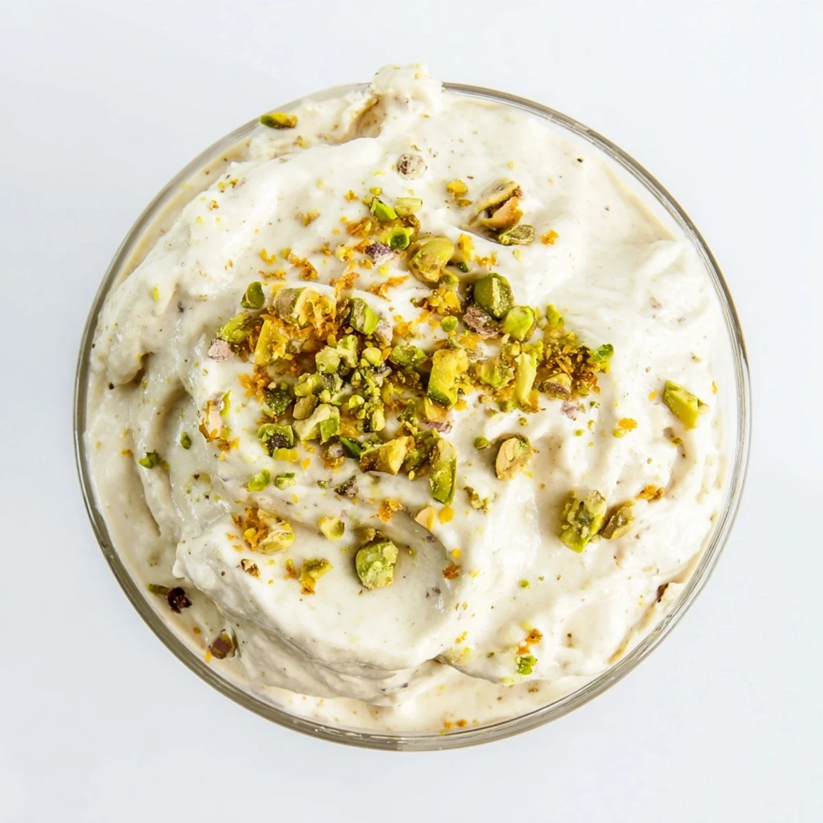 A spoon dips into Lebanese Date Orange Blossom Mousse, revealing airy texture and citrus aromas on a linen table.