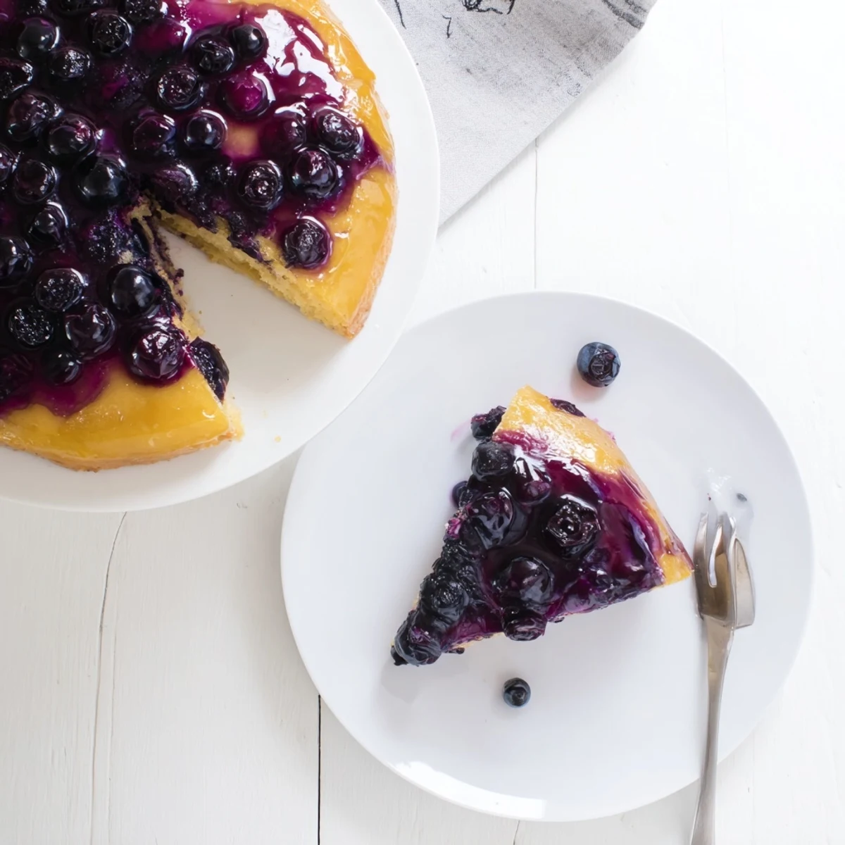 Fresh blueberry upside down cake straight from the oven with glistening berry layer