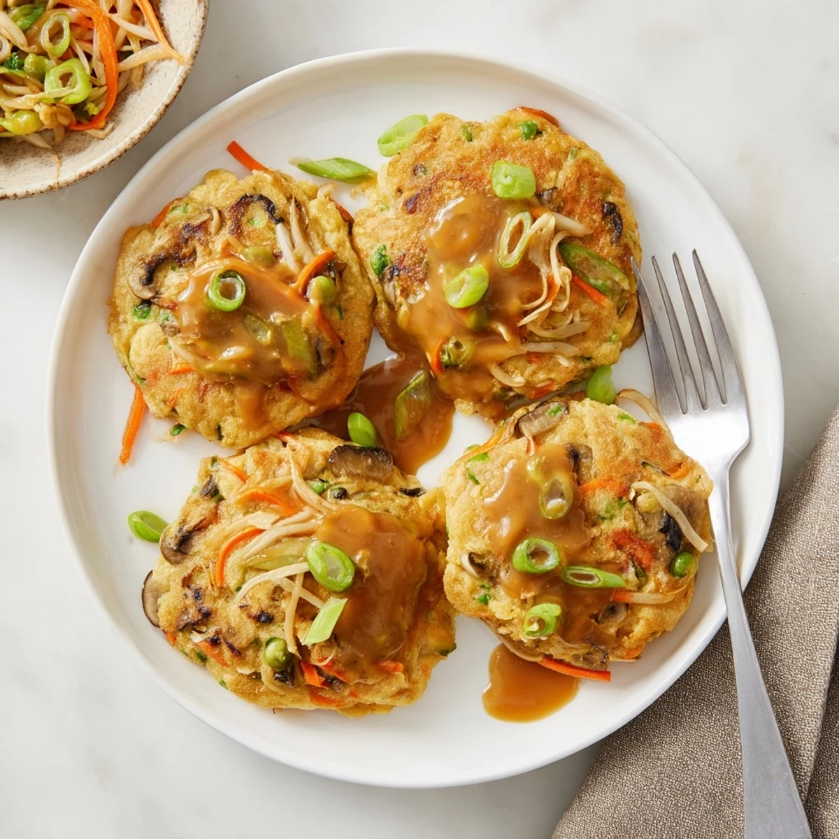 Golden crispy Egg Foo Young patties topped with rich savory brown gravy