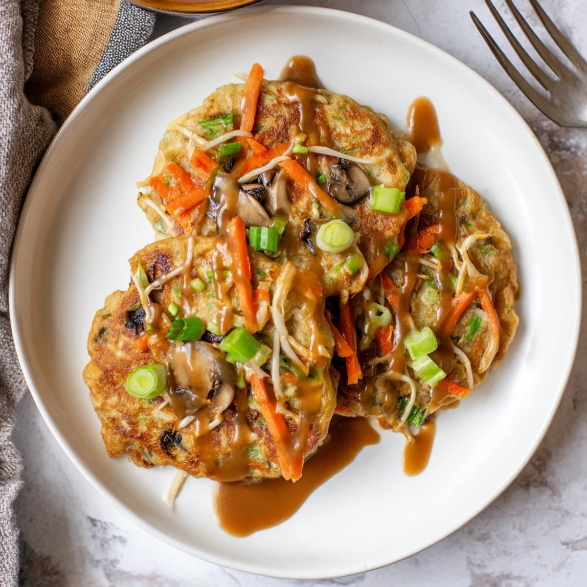 Fluffy vegetable-packed Egg Foo Young omelet fried until perfectly crisp and golden