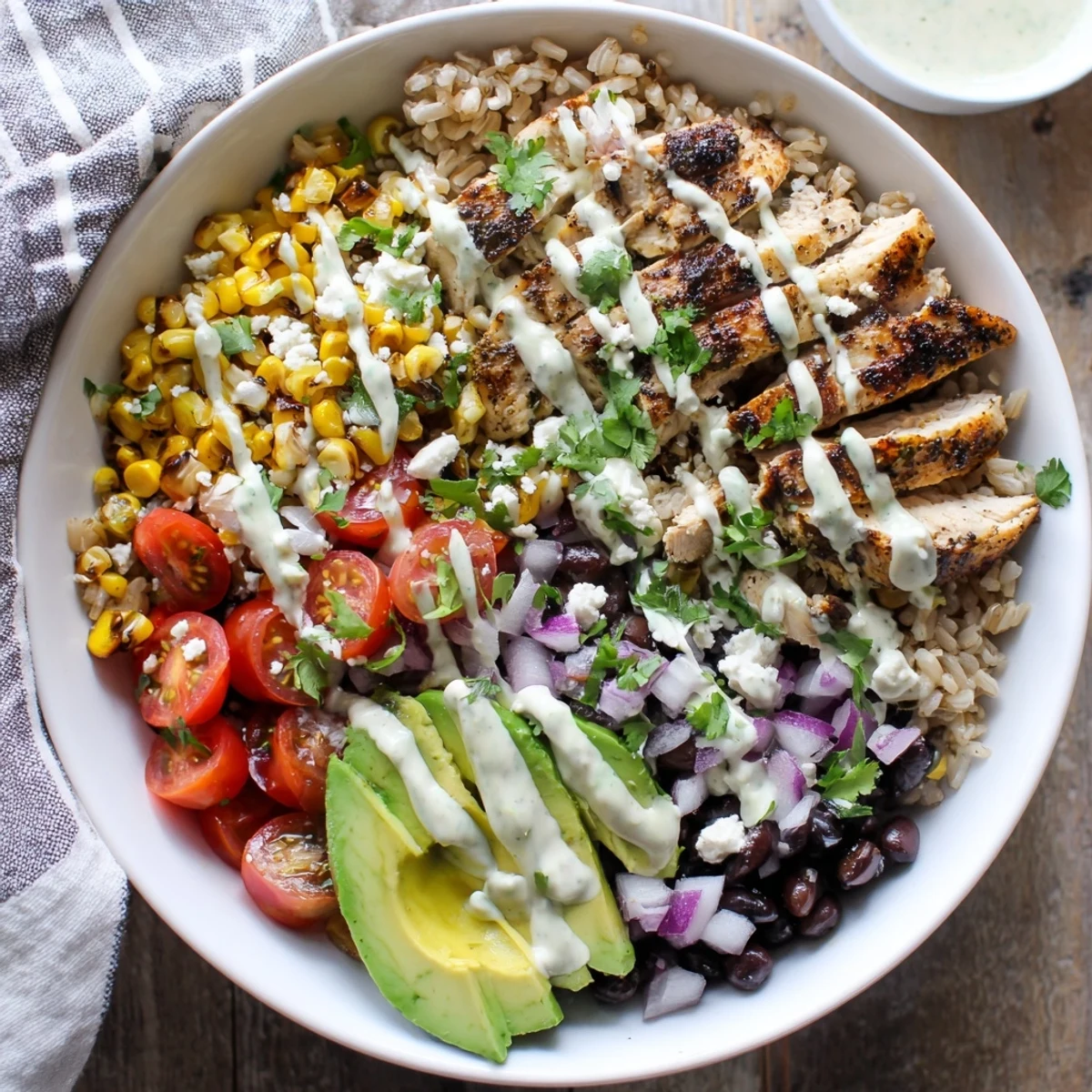 Colorful protein packed street corn chicken bowl with grilled chicken, charred corn, black beans, avocado, and zesty yogurt-lime drizzle over fluffy rice.