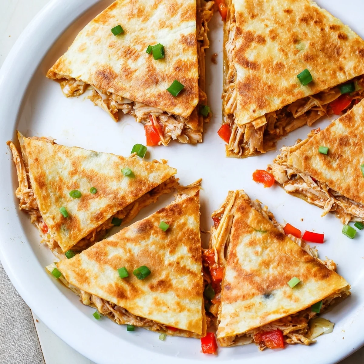 Easy chicken and cheese quesadillas cut into wedges, perfect for quick weeknight dinners
