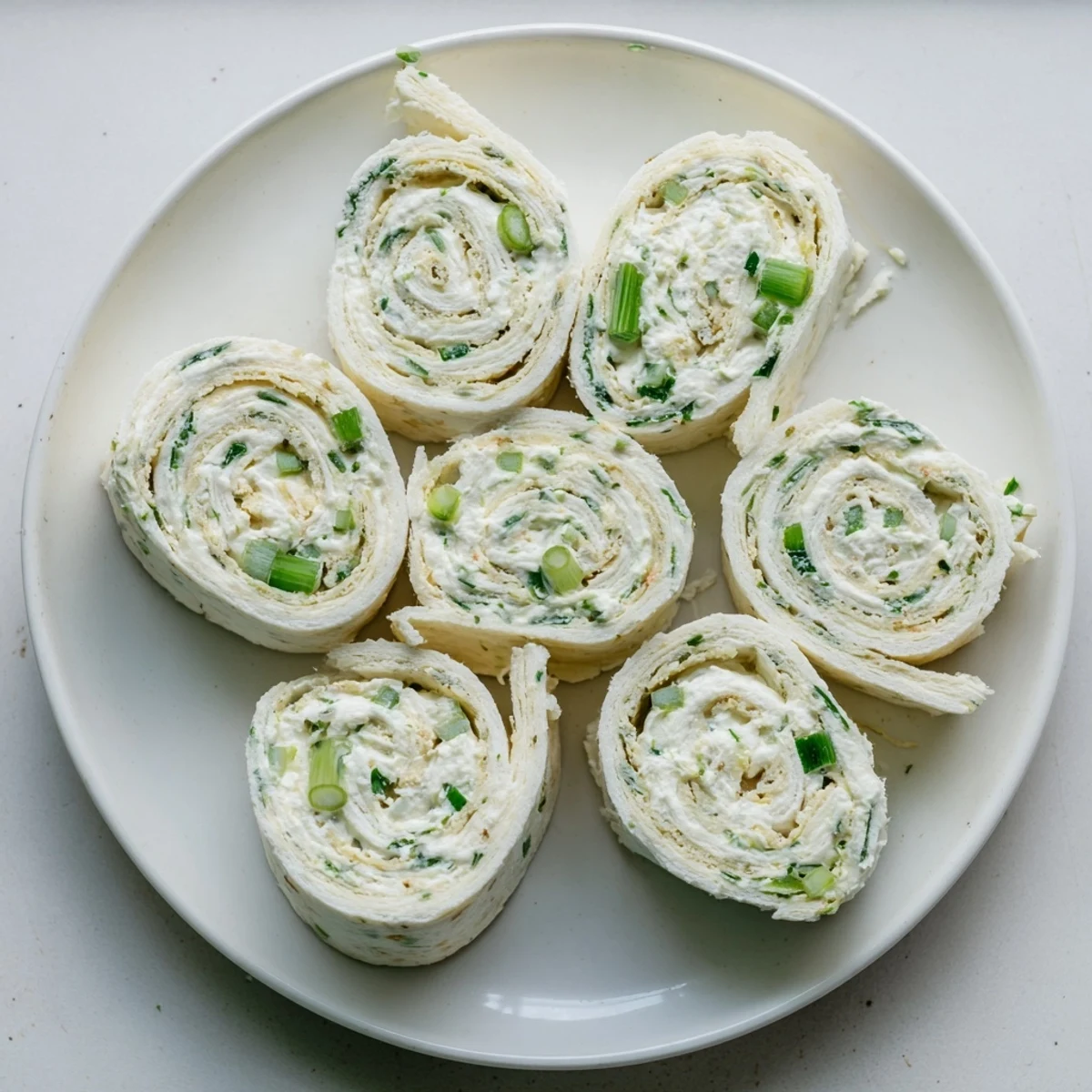 Pickle dip pinwheels spiraled with creamy herbed cheese filling and chopped dill pickles
