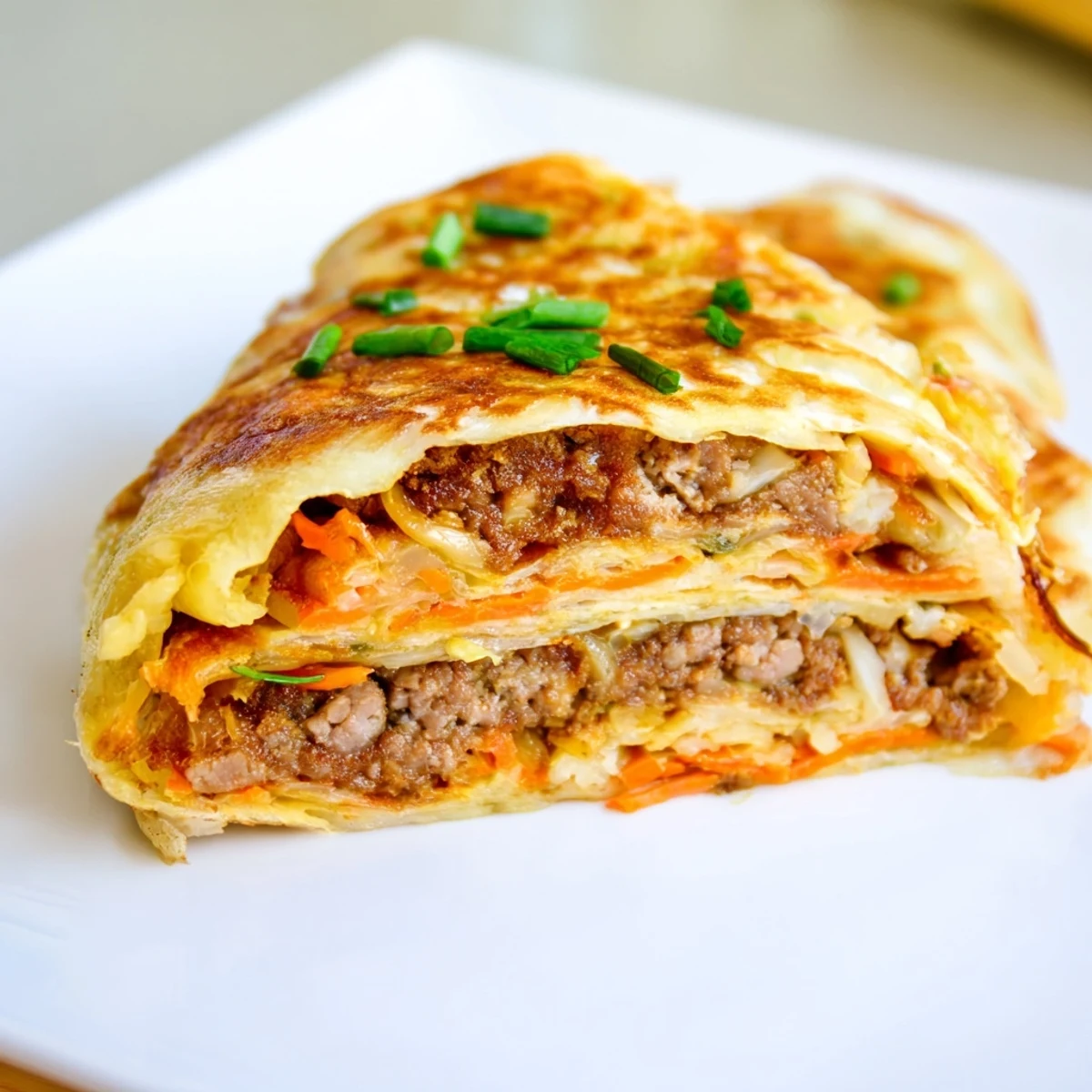 Golden Chinese style savoury stuffed breakfast pancakes filled with seasoned meat and vegetables