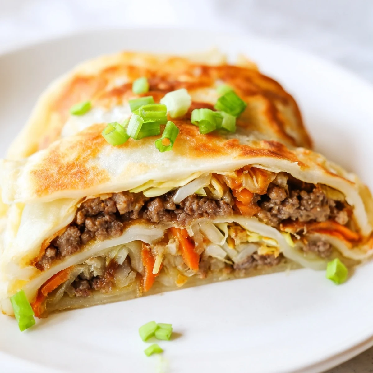 Folded pancake revealing generous savory meat and vegetable stuffing ready for breakfast dipping