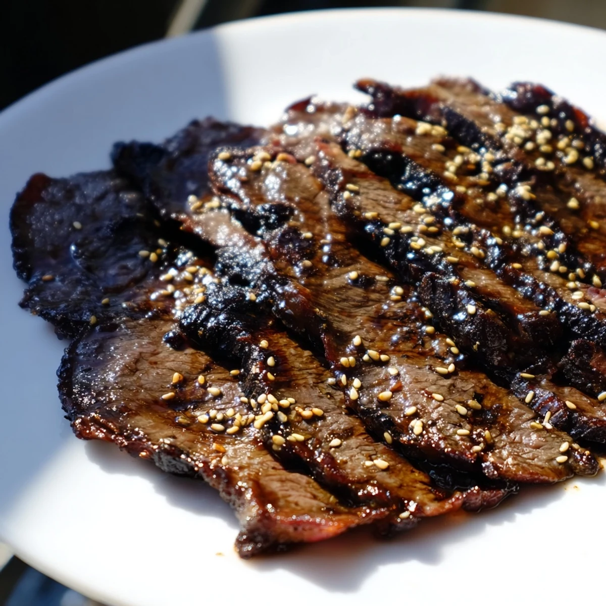 Beef Yakiniku sizzling on a grill pan with caramelized edges and colorful vegetables