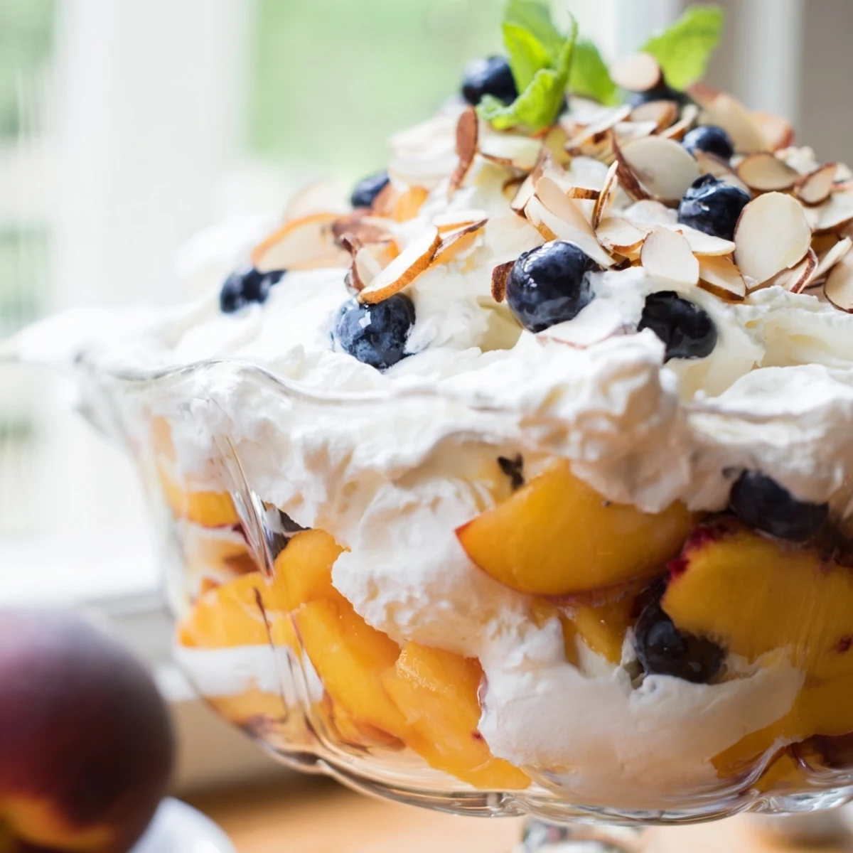 Creamy peaches and cream salad topped with fresh mint and sliced almonds