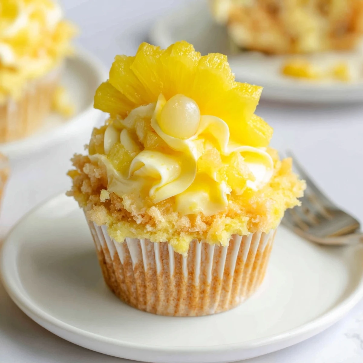 Serve chilled Dole Whip Cupcakes Recipe with toasted pineapple and tiki umbrella