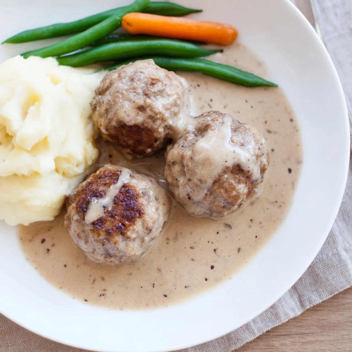 Plate of Homemade Ikea Meatballs browned crisp, fragrant with allspice and nutmeg