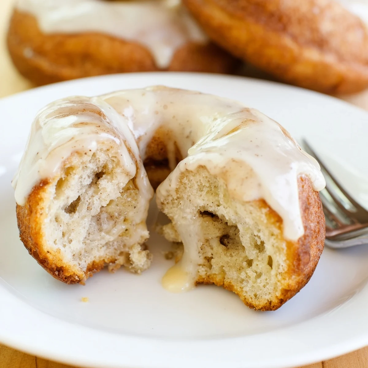 Stacked Banana Donuts served with coffee, tender moist centers and glossy glaze