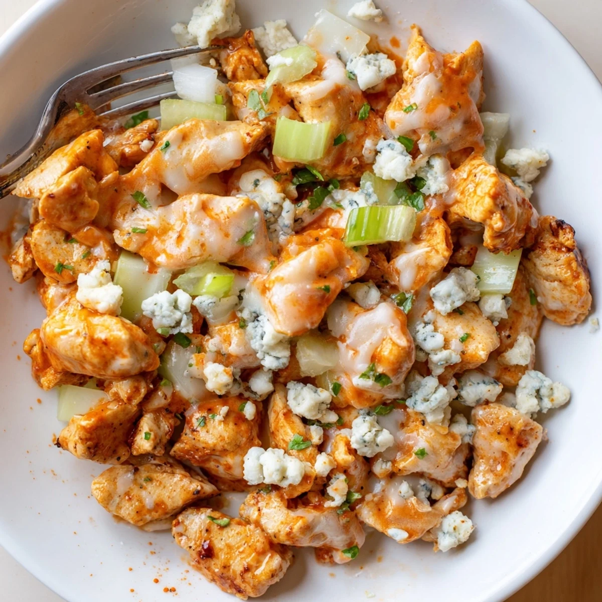 Keto Buffalo Chicken Skillet sizzling in pan with creamy sauce and melted mozzarella  