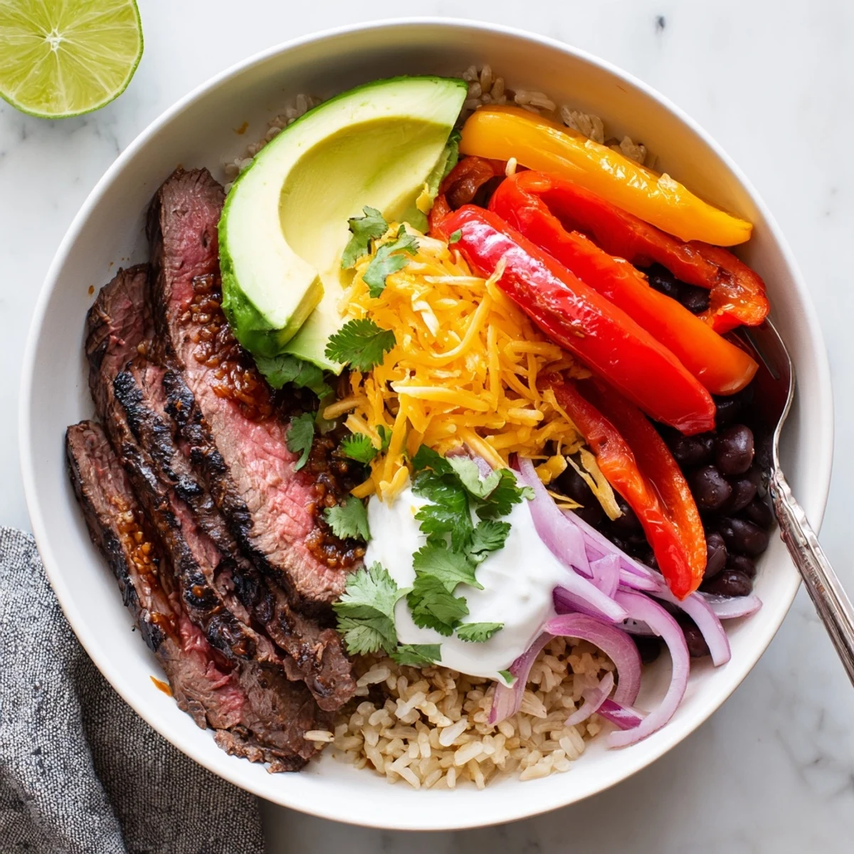 Steak Fajita Power Bowls with sizzling marinated strips, vibrant peppers, fresh avocado