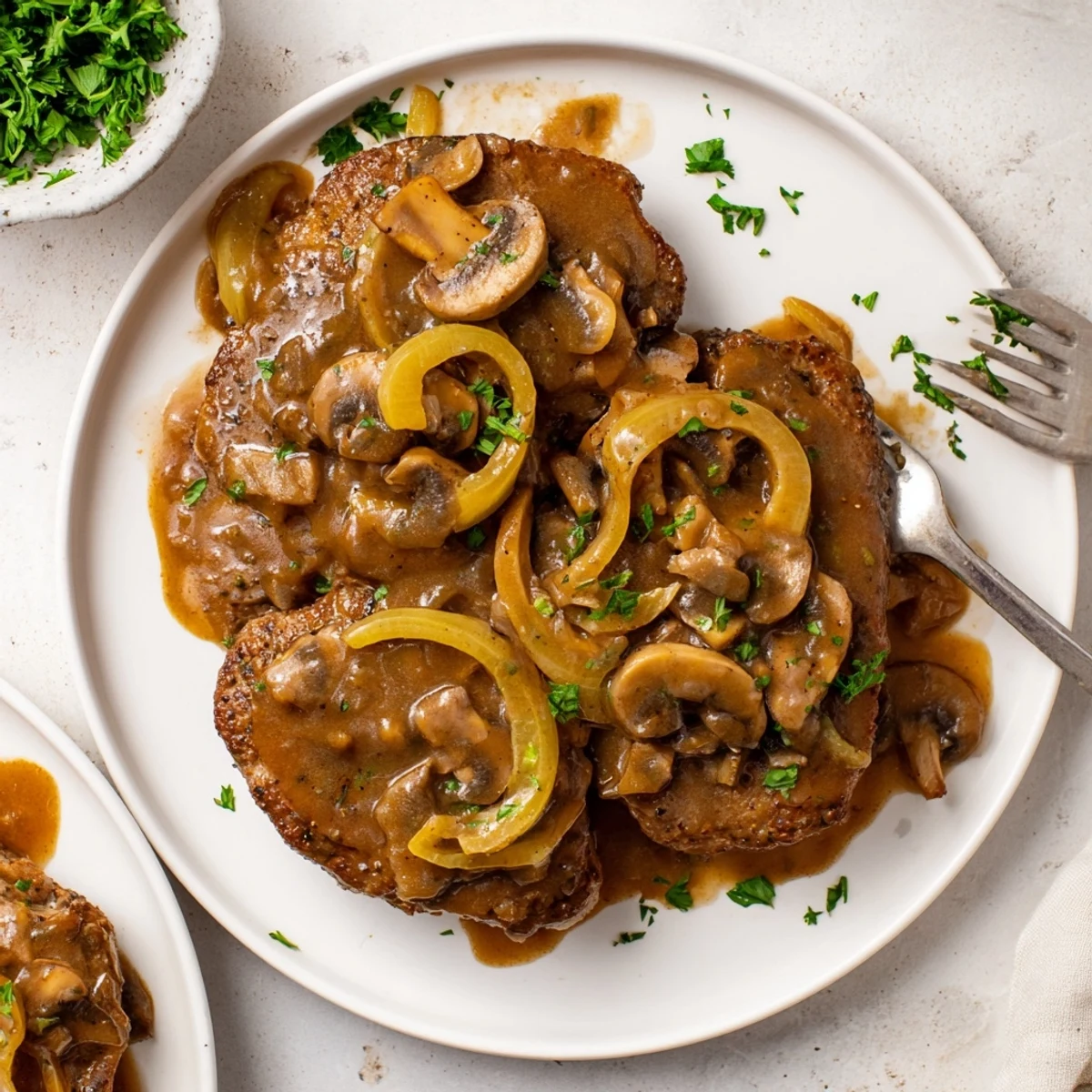 Tender beef cube steaks simmering in savory southern-style mushroom and onion gravy sauce
