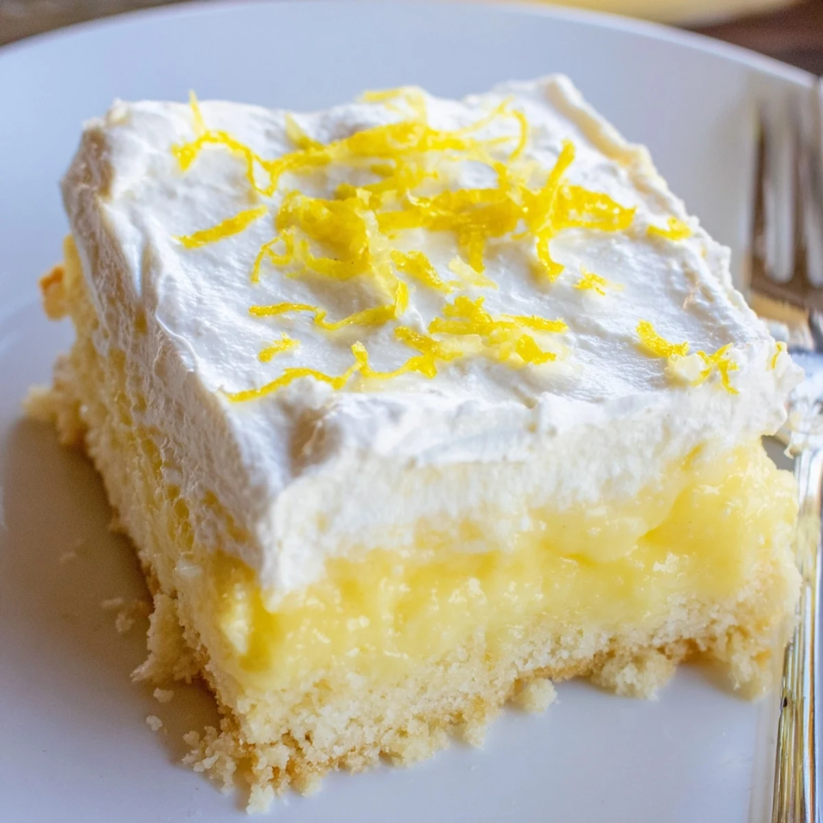 Lemon Lush Cake with creamy lemon layer and pillowy whipped topping