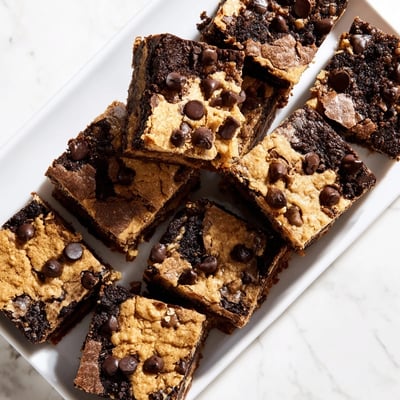 Freshly baked fudgy chewy brookies cut into squares with melty chocolate chips visible